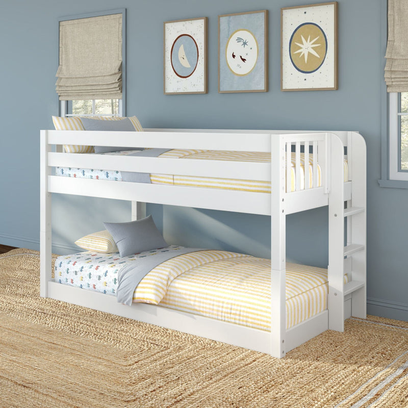 White wooden bunk bed in a children's bedroom with blue walls, yellow-striped bedding, car-print sheets, moon-and-star framed art, beige roman shades and woven jute rug