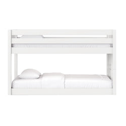 White modern wooden bunk bed with upper guardrail and lower mattress, crisp white bedding, minimalist kids bedroom furniture
