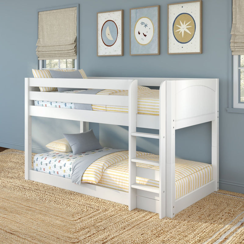 White wooden kids bunk bed in a light-blue children's bedroom with yellow-striped bedding, car-print sheets, gray pillows, framed moon and star wall art, beige roman shades and woven jute rug