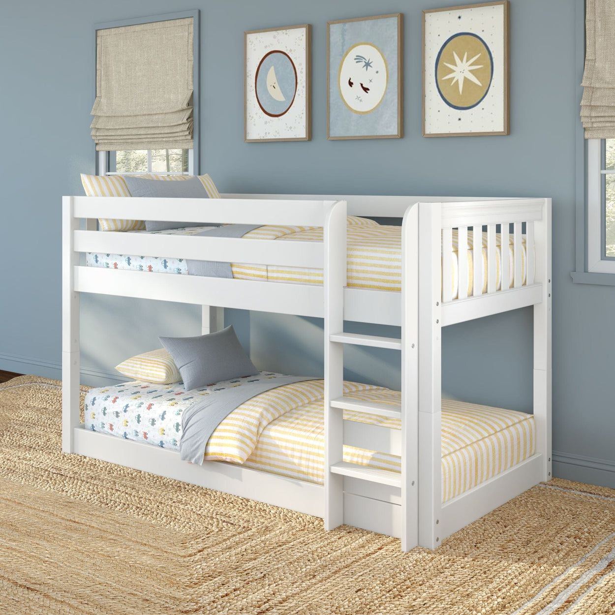 White wooden twin-over-twin bunk bed with ladder in coastal blue kids' bedroom, striped yellow bedding, framed wall art and natural jute rug