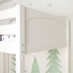 White wooden loft bunk bed with arched plank headboard and safety rail in a modern kids' bedroom featuring green pine tree wall decals and cloud stickers