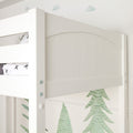 Close-up of white wooden bunk bed headboard and safety rail in kids' bedroom with green tree mural
