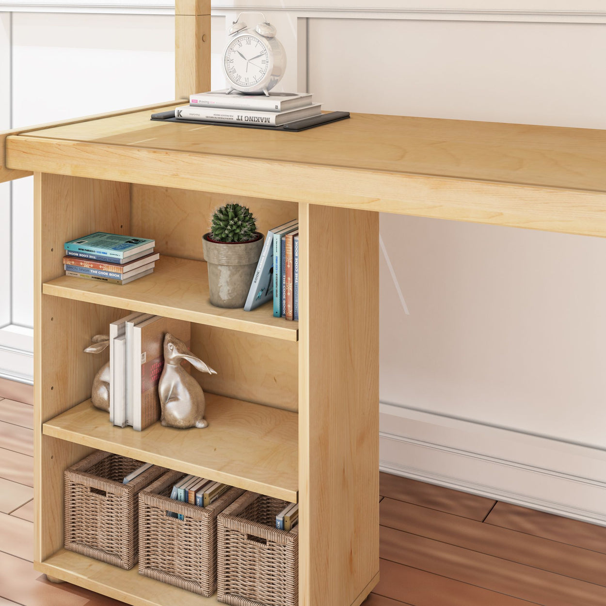 Wooden desk with shelves featuring books, a clock, a potted cactus, decorative rabbits, and woven baskets for home office organization.