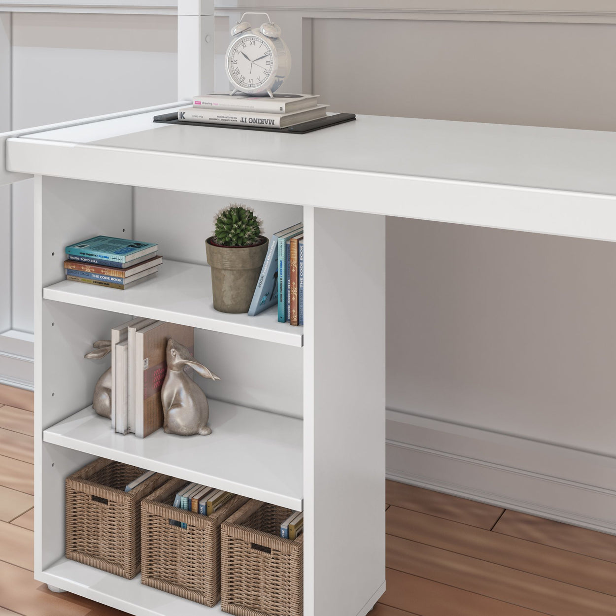 White desk with built-in shelves featuring books, decorative items, and storage baskets on a wooden floor.