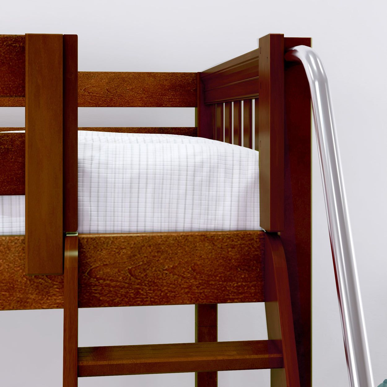 Wooden bunk bed corner with white mattress and metal safety rails.