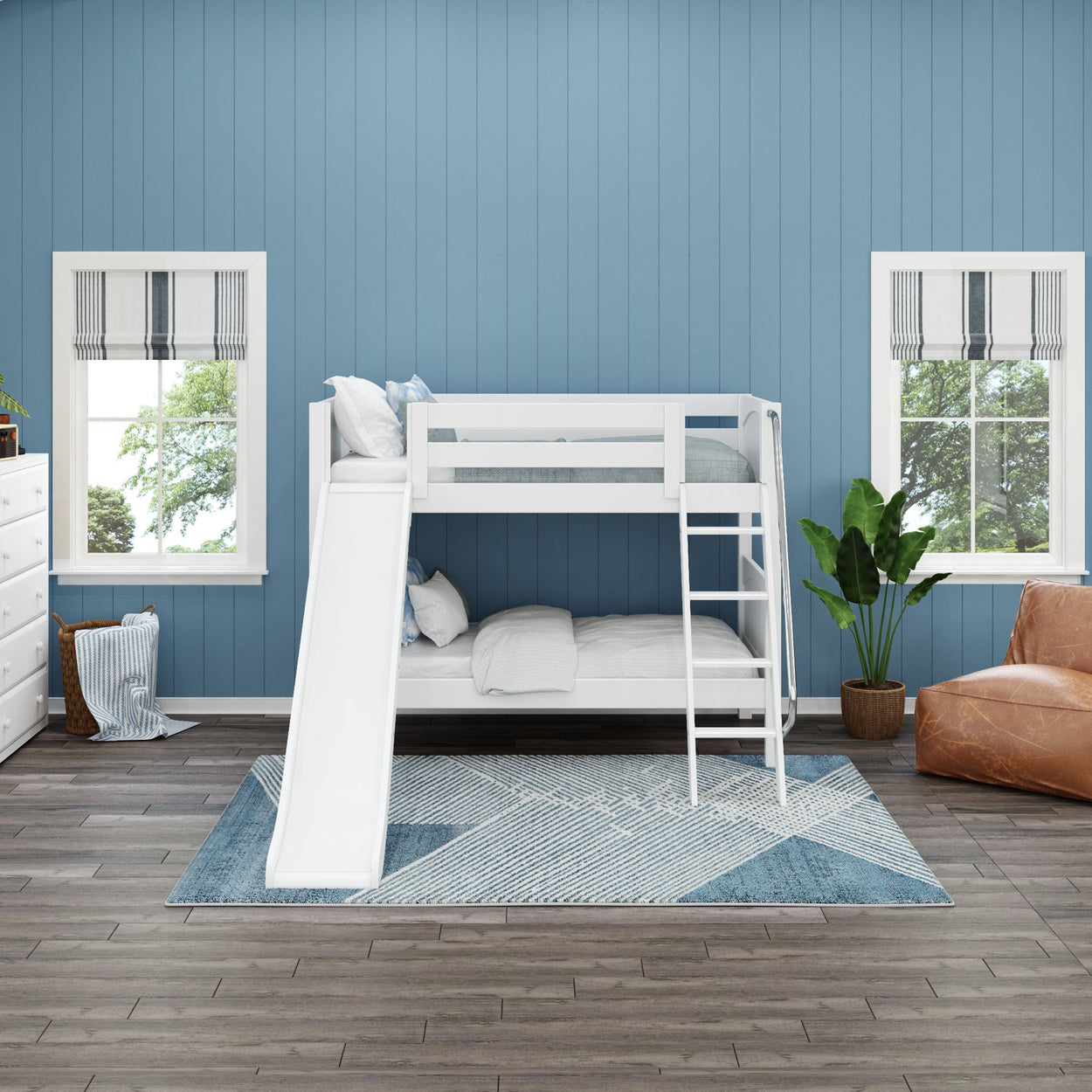 White bunk bed with slide in a blue and white children's room with modern decor.