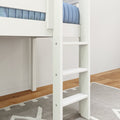 Close-up of white wooden ladder on loft bunk bed with blue mattress, gray patterned rug and hardwood floor