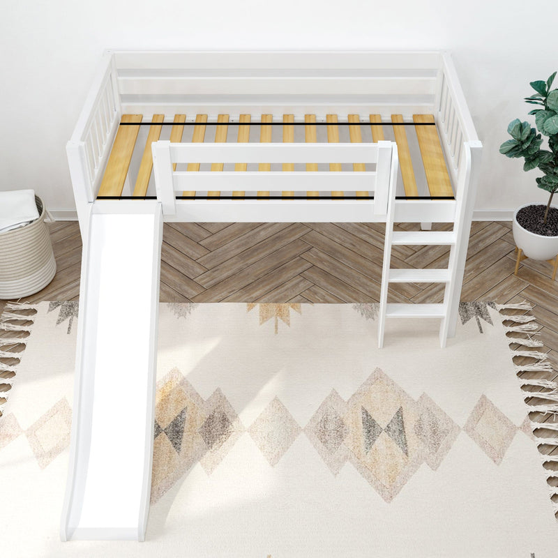White children's loft bed with slide and ladder, natural wood slats, patterned beige rug and potted plant in modern nursery