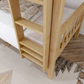 Close-up of natural solid pine bunk bed ladder and guardrail with striped mattress, plaid blanket, and wooden bedroom floor rug