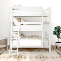 Modern white wooden bunk bed with ladder, neutral bedding and decorative pillows on a boho rug in a bright minimalist kids' bedroom