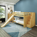 Wooden bunk bed with slide and storage stairs in a children's coastal-style bedroom with blue paneled accent wall, dresser, and geometric rug