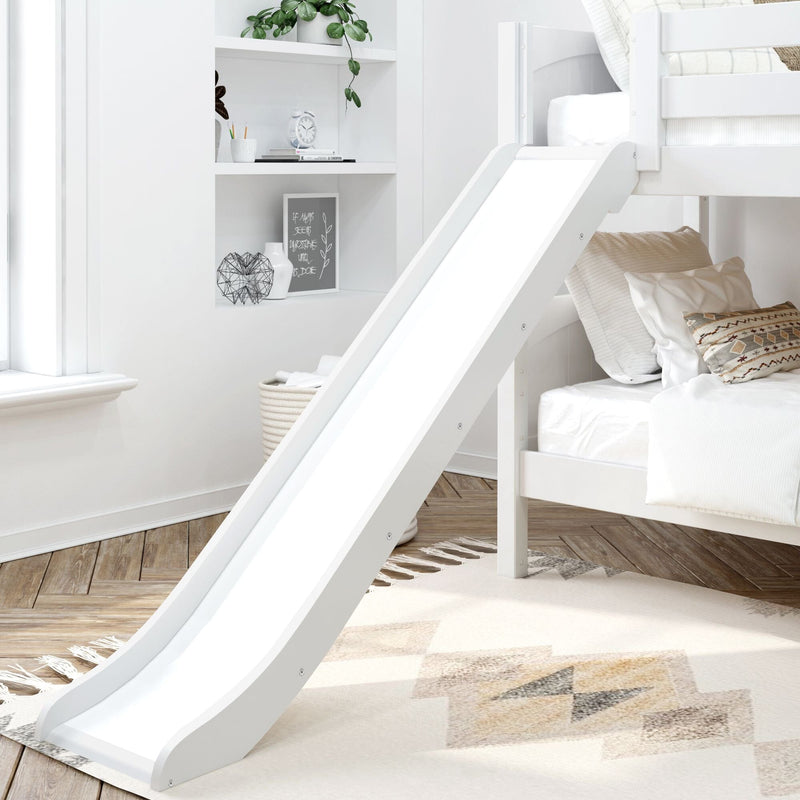Modern white children's bunk bed with slide and built-in shelves, neutral bedding and patterned pillows, decorative plant, alarm clock and woven basket on herringbone hardwood floor in a bright minimalist kids' bedroom