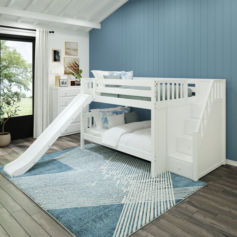 White loft bunk bed with stairs and slide in modern kids bedroom, blue vertical accent wall, white dresser and patterned blue rug
