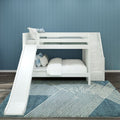 White wooden bunk bed with slide and built‑in storage stairs in a modern kids bedroom featuring a blue paneled accent wall, layered pillows, cozy bedding and a patterned blue rug