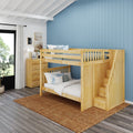 Wooden bunk bed with storage stairs in a coastal-style kids bedroom with blue vertical shiplap accent wall, dresser and lamp