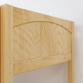 Close-up of light pine bunk bed headboard with arched top, visible wood grain, slatted panel and metal bolt fasteners, bedroom furniture