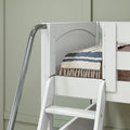 White wooden bunk bed ladder and safety rail with chrome handrail, striped quilt on lower bunk against pale green paneled wall