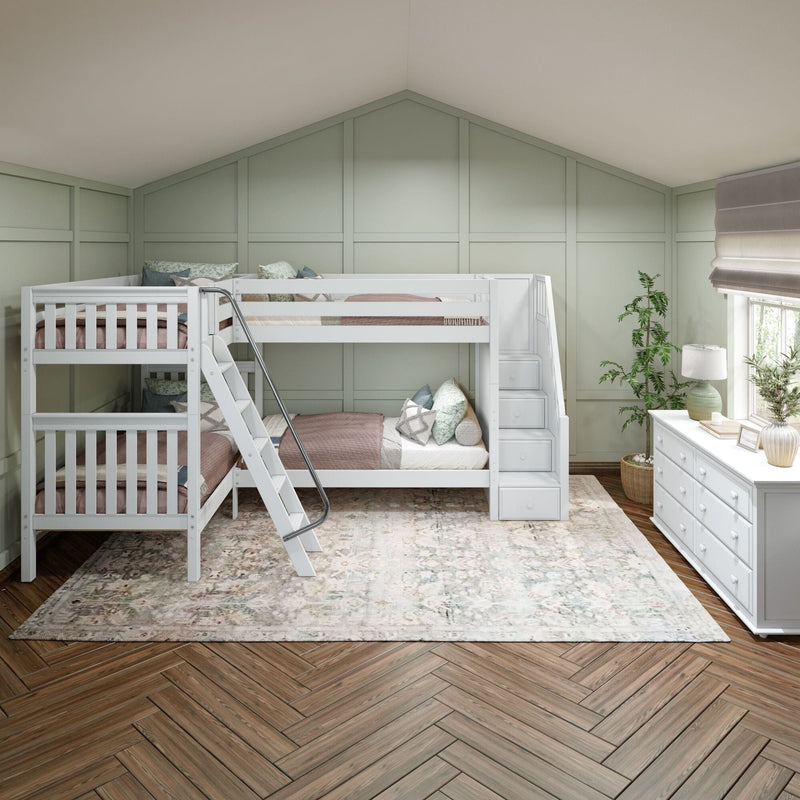 Kids bedroom with white twin-over-twin bunk beds and stair-storage, sage green paneled accent wall, white dresser, area rug and herringbone wood floor