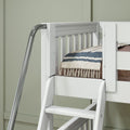 White wooden loft bed with ladder and chrome safety rail, blue-striped quilt and tasseled blanket