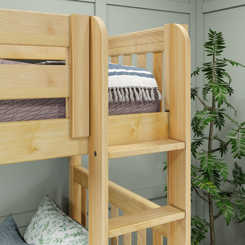 Solid pine bunk bed ladder and safety rail close-up with striped throw blanket and tasseled edge on mattress, natural wood finish in a cozy modern bedroom with green plant