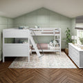White bunk beds in a cozy children's bedroom with green board-and-batten accent wall, ladder, patterned bedding, potted plant, white dresser and herringbone wood floor