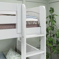 White wooden bunk bed ladder and safety rail with striped tassel throw and cozy bedding in a modern kids’ bedroom with indoor plant