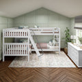 White twin bunk beds in a cozy children's bedroom with sage green paneled accent wall, herringbone hardwood floor, patterned rug and white dresser