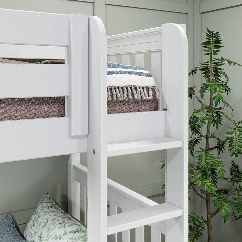 Close-up of a white wooden bunk bed ladder and safety rails with textured blankets and pillows in a cozy kids’ bedroom with a green accent wall and potted plant