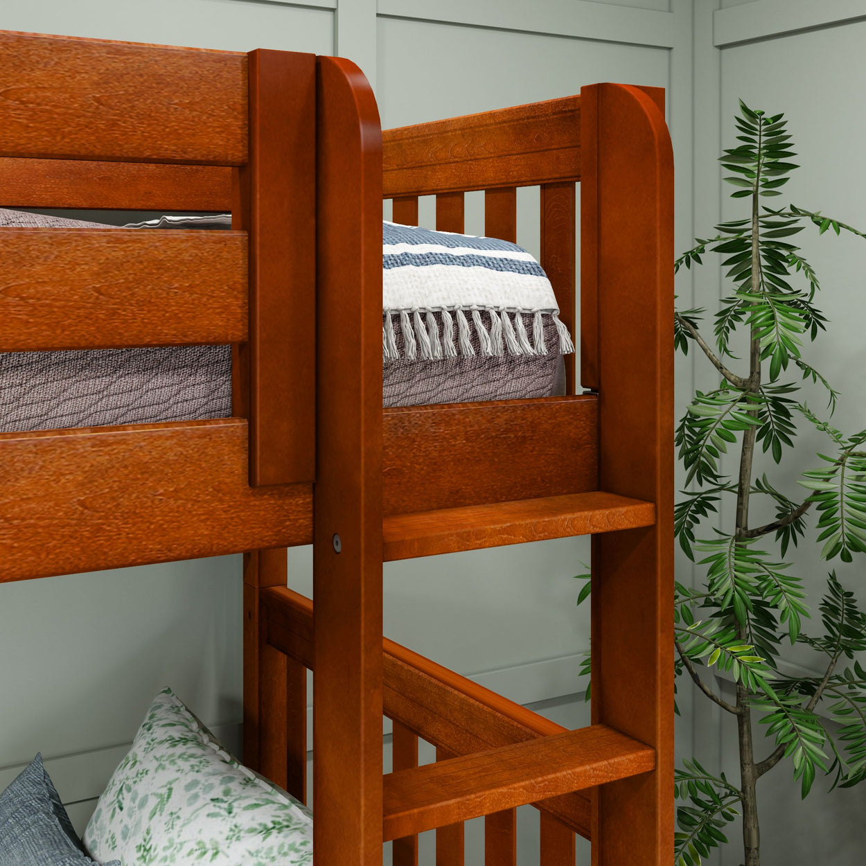 Wooden bunk bed with cozy striped blanket, indoor plant, and decorative pillows in a modern bedroom setting.