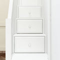 White built-in under-stair storage drawers with paneled fronts and round knobs, space-saving staircase cabinet solution
