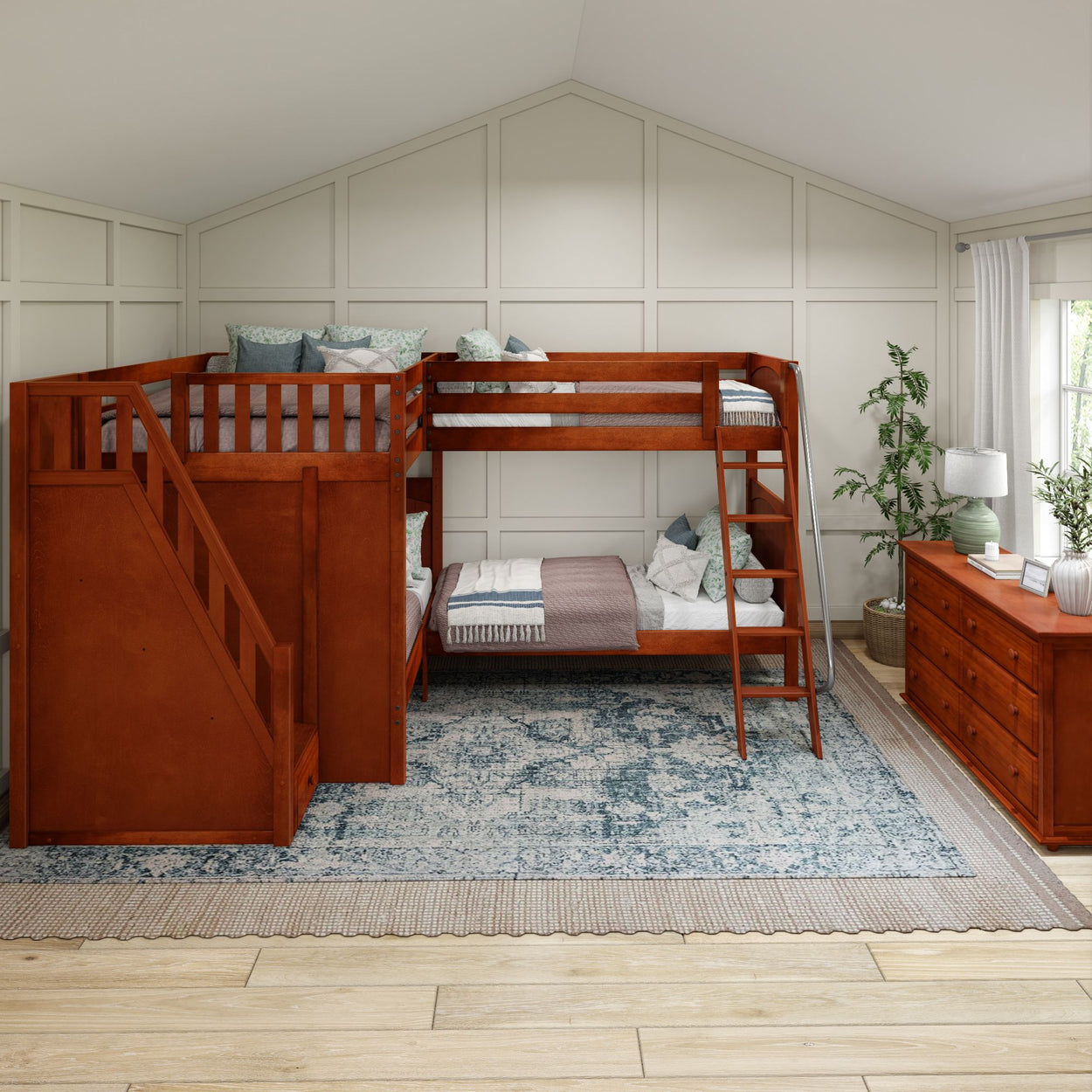 Wooden bunk bed with stairs in stylish bedroom featuring blue patterned rug and dresser.