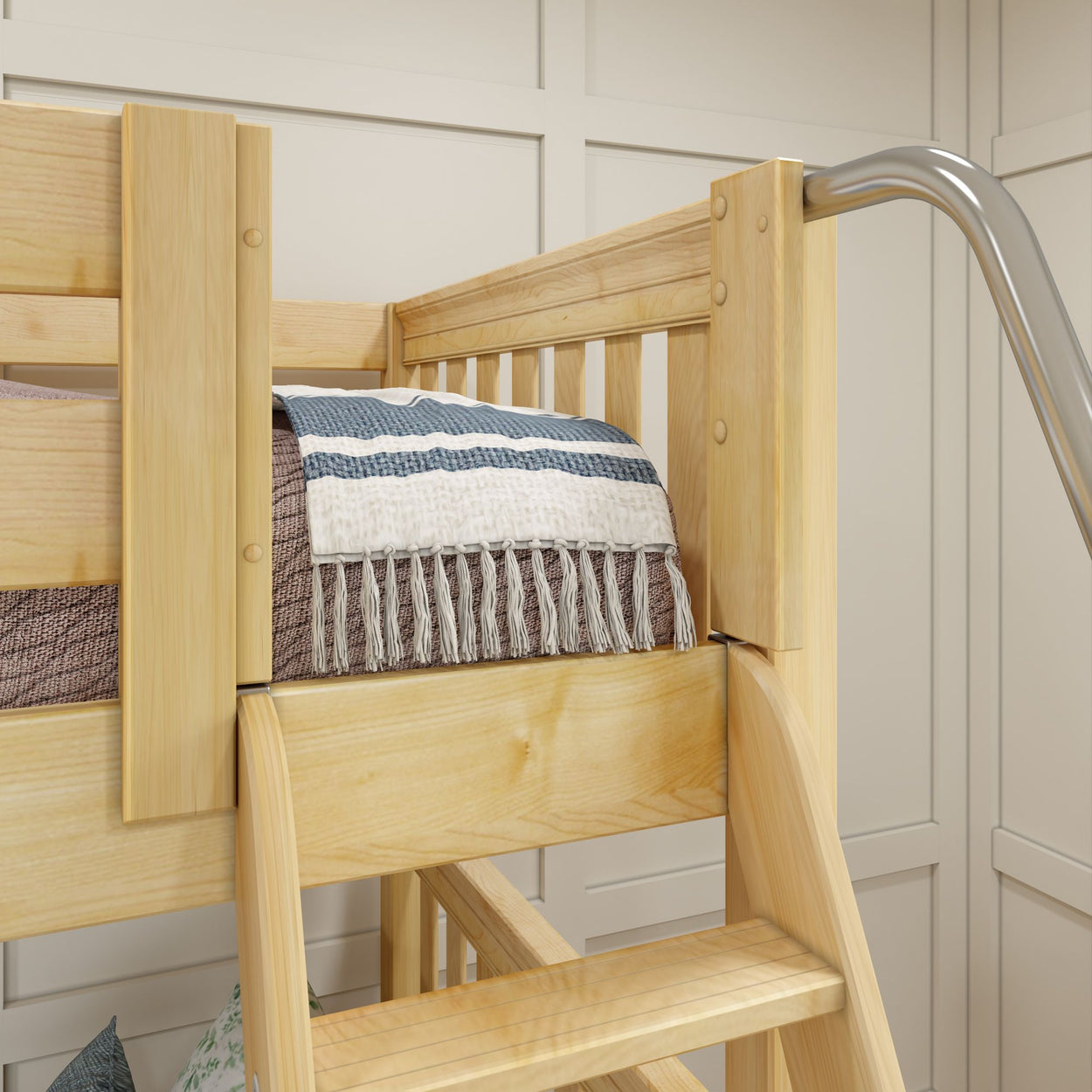 Wooden bunk bed with a cozy fringed blanket in a modern bedroom.