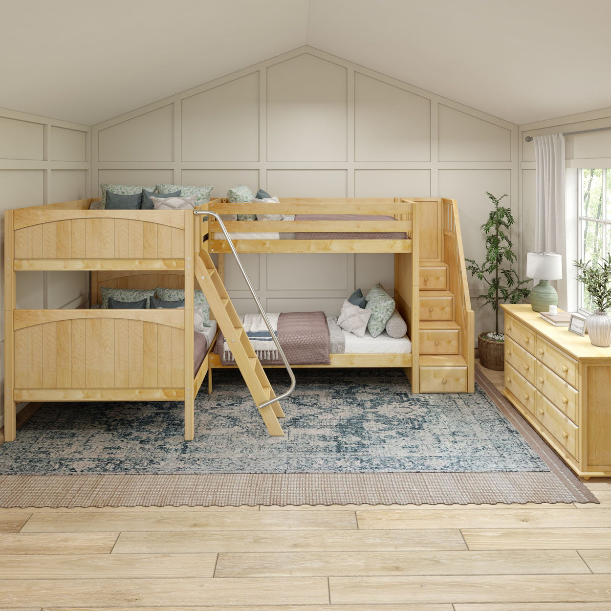 Wooden bunk bed with storage steps in a cozy kids' room featuring a patterned rug and natural light.