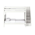 White wooden twin-over-full bunk bed with built-in staircase storage drawers, guardrails and white bedding for modern kids' bedroom
