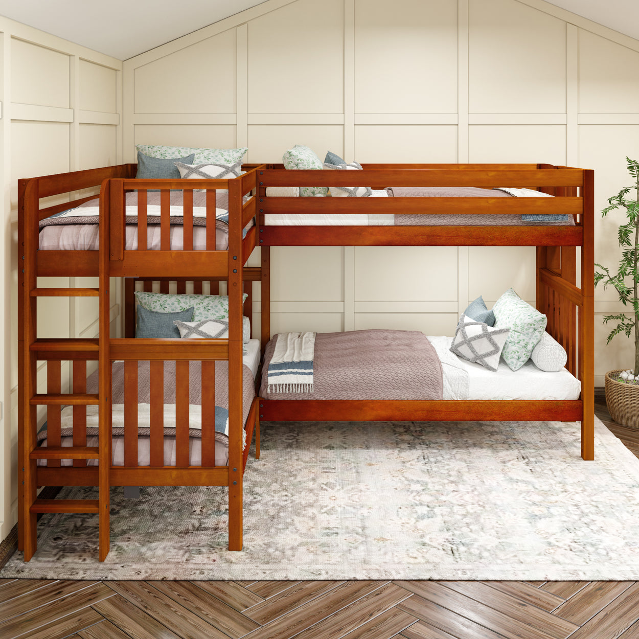 Wooden triple bunk bed in a cozy bedroom with patterned rug and decorative cushions.