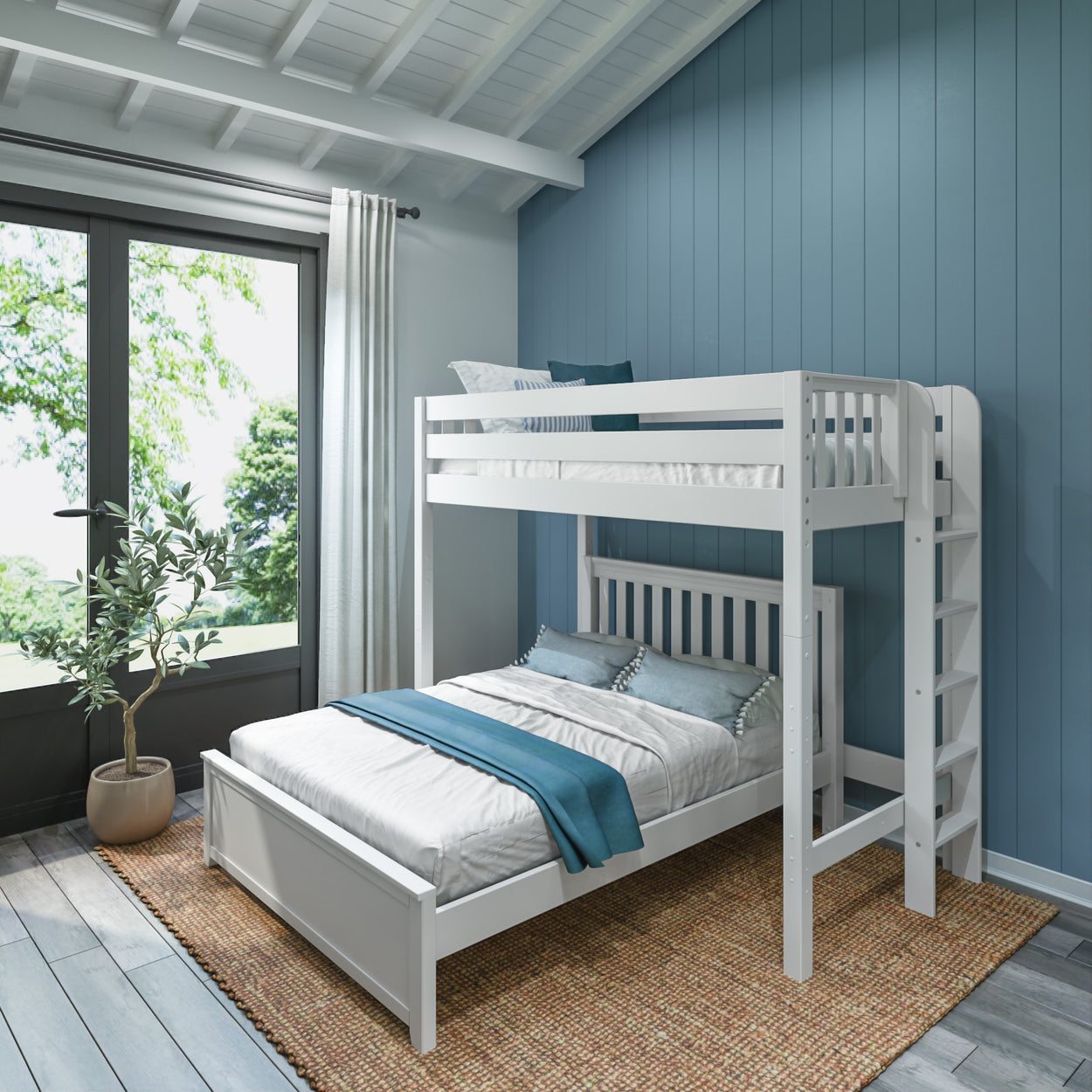 White twin over full bunk bed in a modern bedroom with blue accent wall, potted plant, and natural light streaming through large windows.