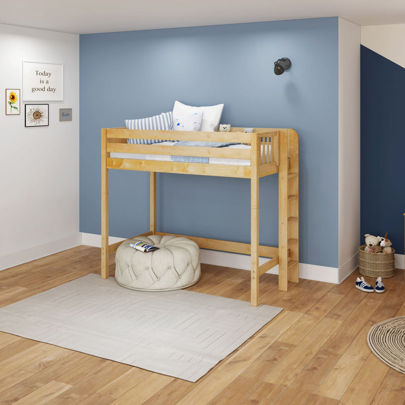 Kids loft bed in modern children's bedroom with natural wood frame, blue accent wall, framed art, striped pillows and toy basket