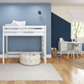 Children's bedroom with white loft bunk bed, blue and navy geometric accent walls, study desk, toy basket and hardwood floors