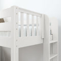 Close-up of white wooden bunk bed for kids with slatted safety rails, ladder steps and striped mattress sheet