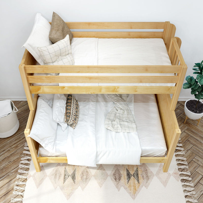 Top-down view of a natural wood bunk bed with white bedding, textured neutral throw pillows, patterned rug and potted plant in a Scandinavian-style kids' bedroom