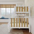 Modern white bunk bed with natural wood slats in a bright kids' bedroom with window seat, blue cloud pillow, and beige geometric wallpaper