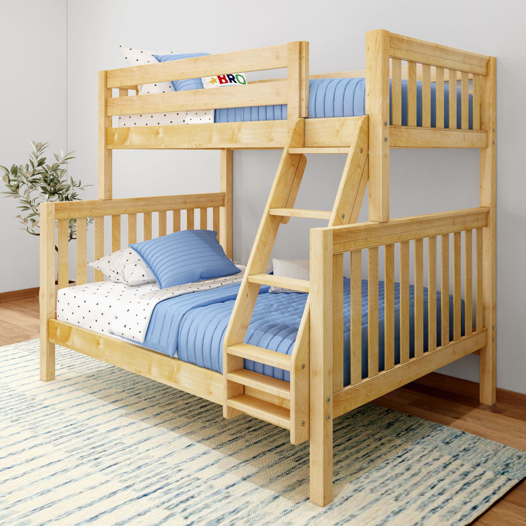 Wooden bunk bed with blue bedding and polka dot sheets in a bright bedroom setting.