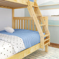 Natural solid wood twin-over-twin bunk bed with angled ladder, blue quilt and star-print sheets in kids' bedroom
