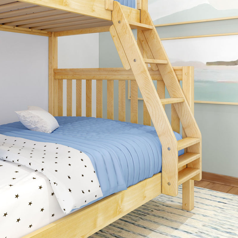 Natural solid wood twin-over-twin bunk bed with angled ladder, blue quilt and star-print sheets in kids' bedroom