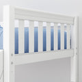 White wooden baby crib rail close-up with vertical slats and blue bedding in a modern nursery — safety rails