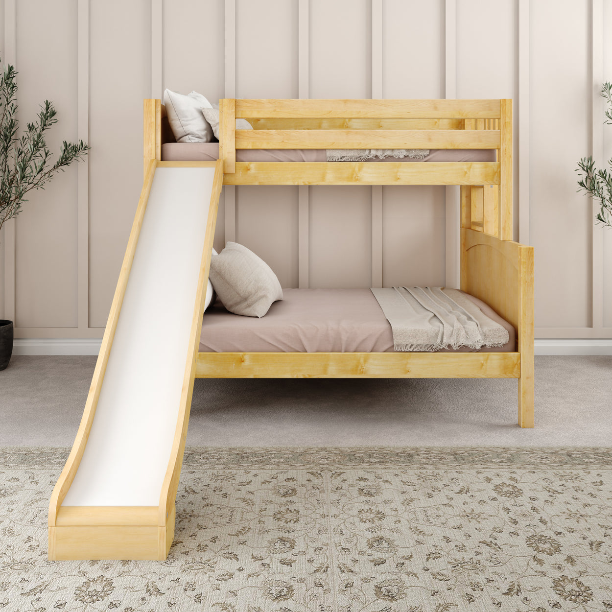 Wooden bunk bed with slide in minimalist bedroom setting, gray carpet, and decorative plants.