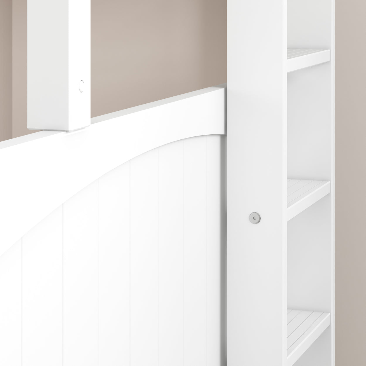 White interior barn door with built-in shelving against beige wall.
