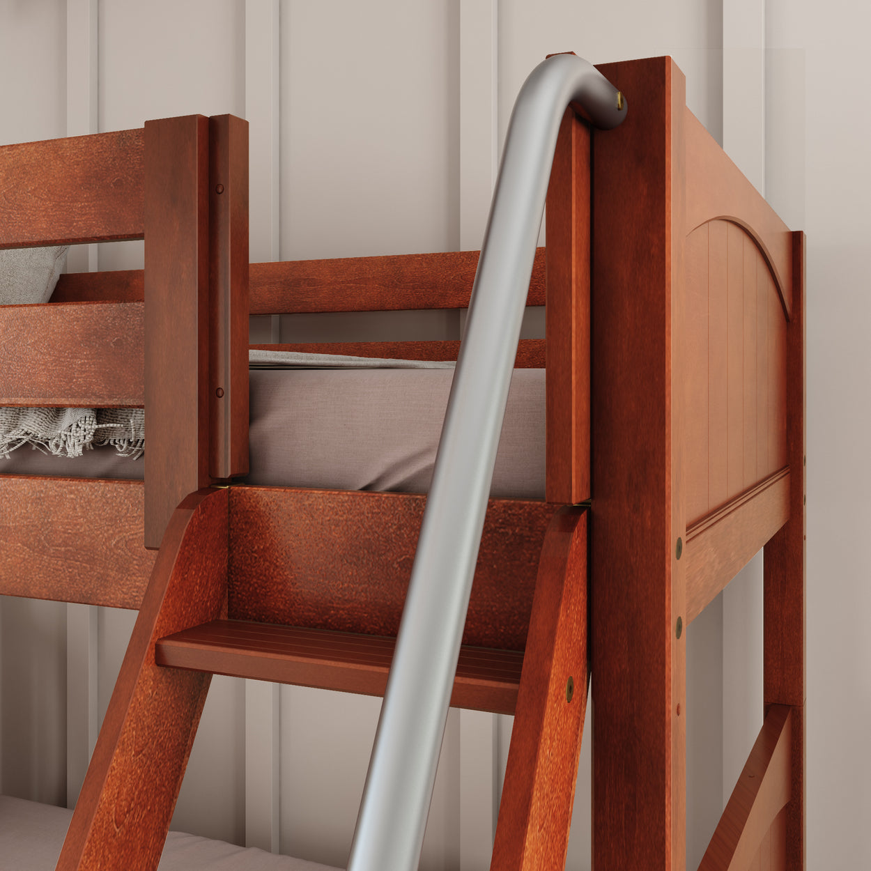 Wooden bunk bed with modern metal safety rail and cozy bedding, ideal for children's bedrooms.