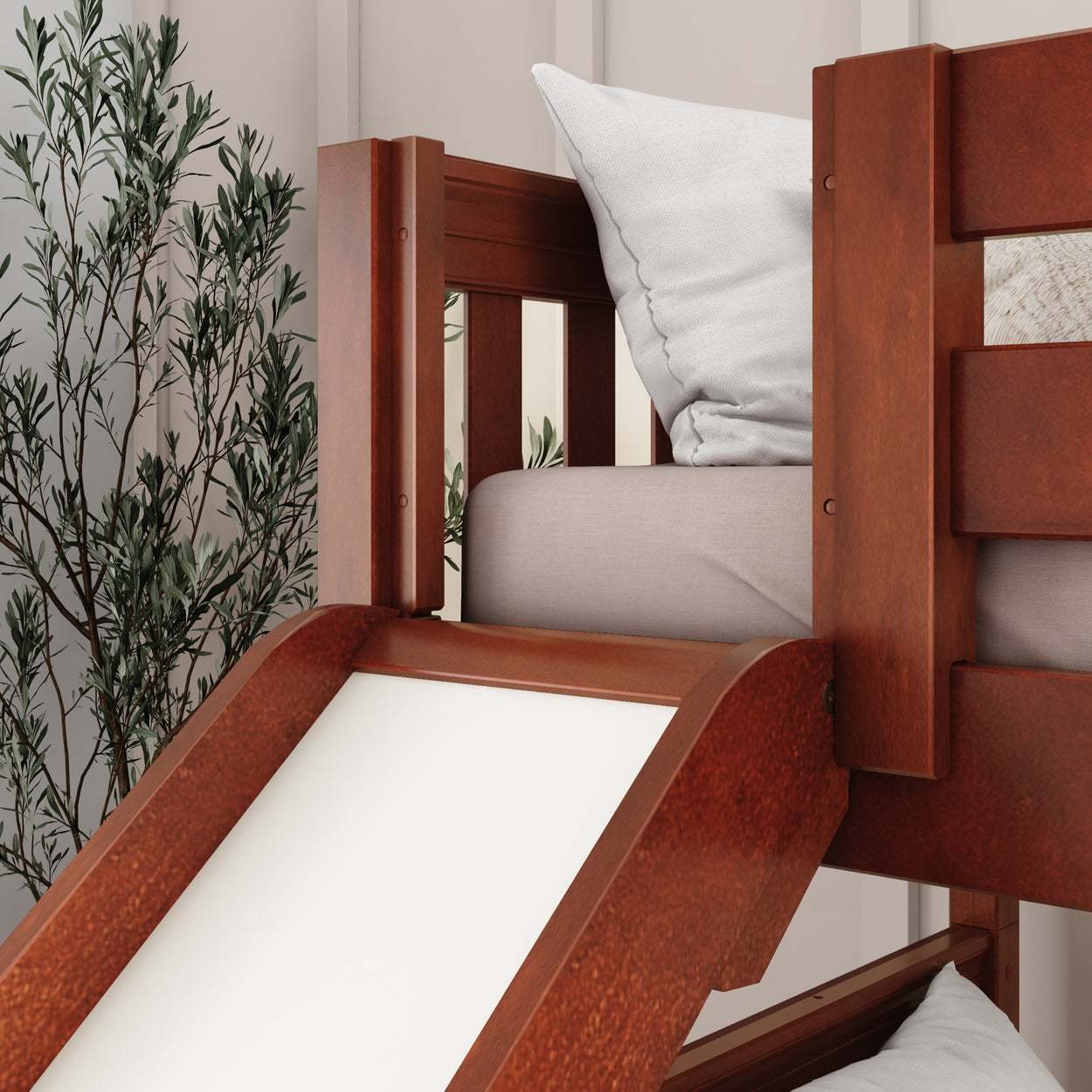 Wooden bunk bed with slide and white pillow for kids' bedroom.