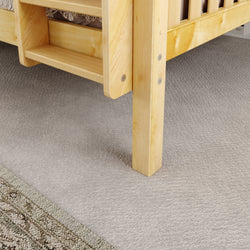 Wooden bunk bed leg on soft carpet in a cozy bedroom setting.